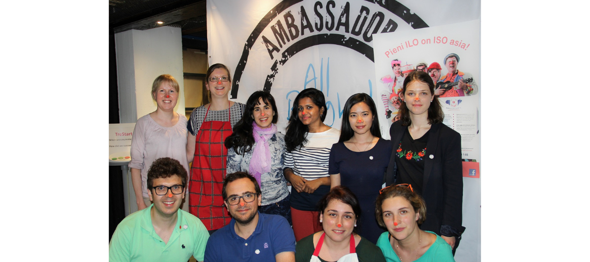 A group of people in front of a sign that says "Amabassadors"