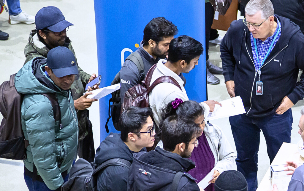 Jobseekers at JOb Fair Tampere chatting with an employer.