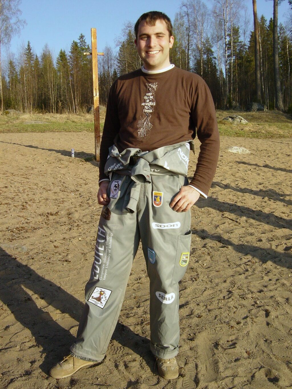 Christian standing outside with his university overalls